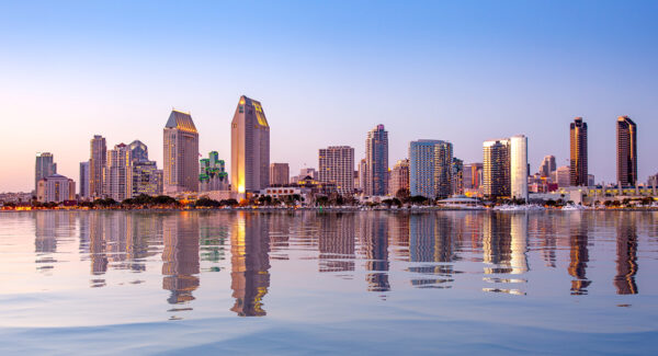 Sunset illuminating the tall skyscrapers of San Diego in California from Centennial Park in Coronado with artificial water reflection