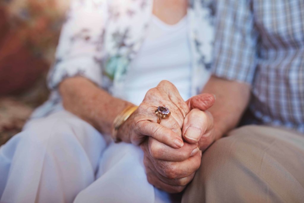 Senior couple holding hands