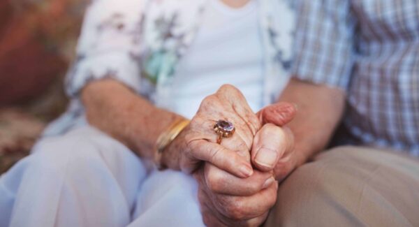 Senior couple holding hands