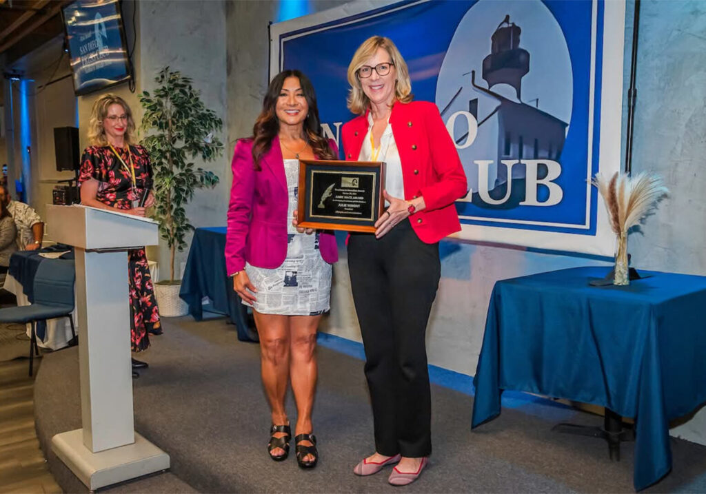 Julie Wright accepts the 2025 Andy Mace Award from the San Diego Press Club for for Outstanding Contribution in Public Relations