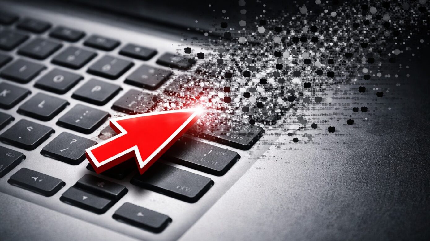 Cursor hovers over disintegrating keyboard - represents AI, journalism, newstinction