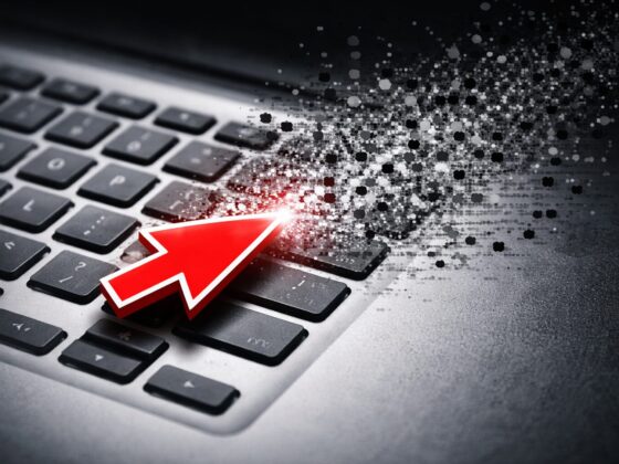 Cursor hovers over disintegrating keyboard - represents AI, journalism, newstinction